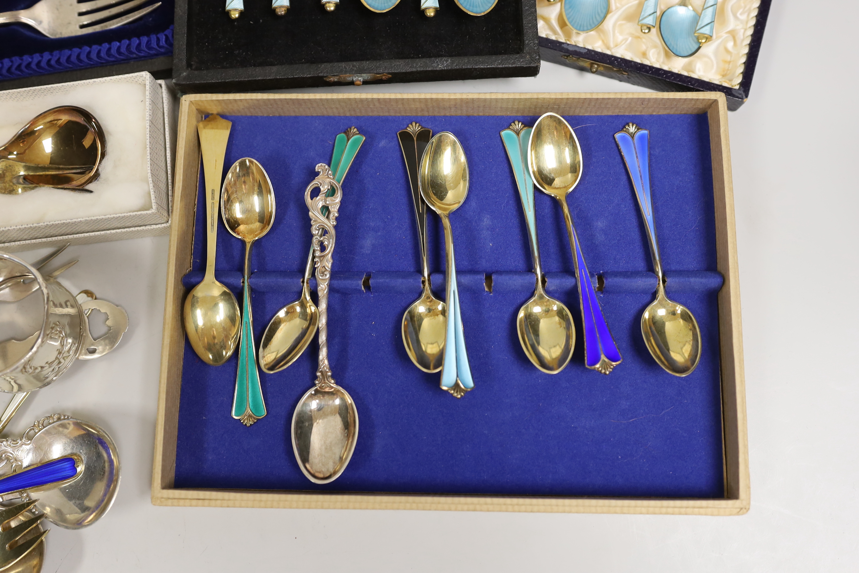 Two sets of eight Norwegian 925S and polychrome enamelled coffee spoons, by David Andersen, one other cased set of six Norwegian 925 and enamelled coffee spoons, a similar spoon and fork, a set of twelve Danish sterling